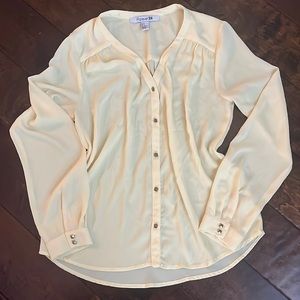 Yellow blouse with bronze geometric buttons